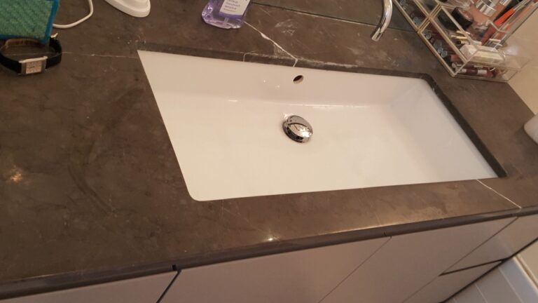 Thick Limescale Damage On a Marble Vanity Top